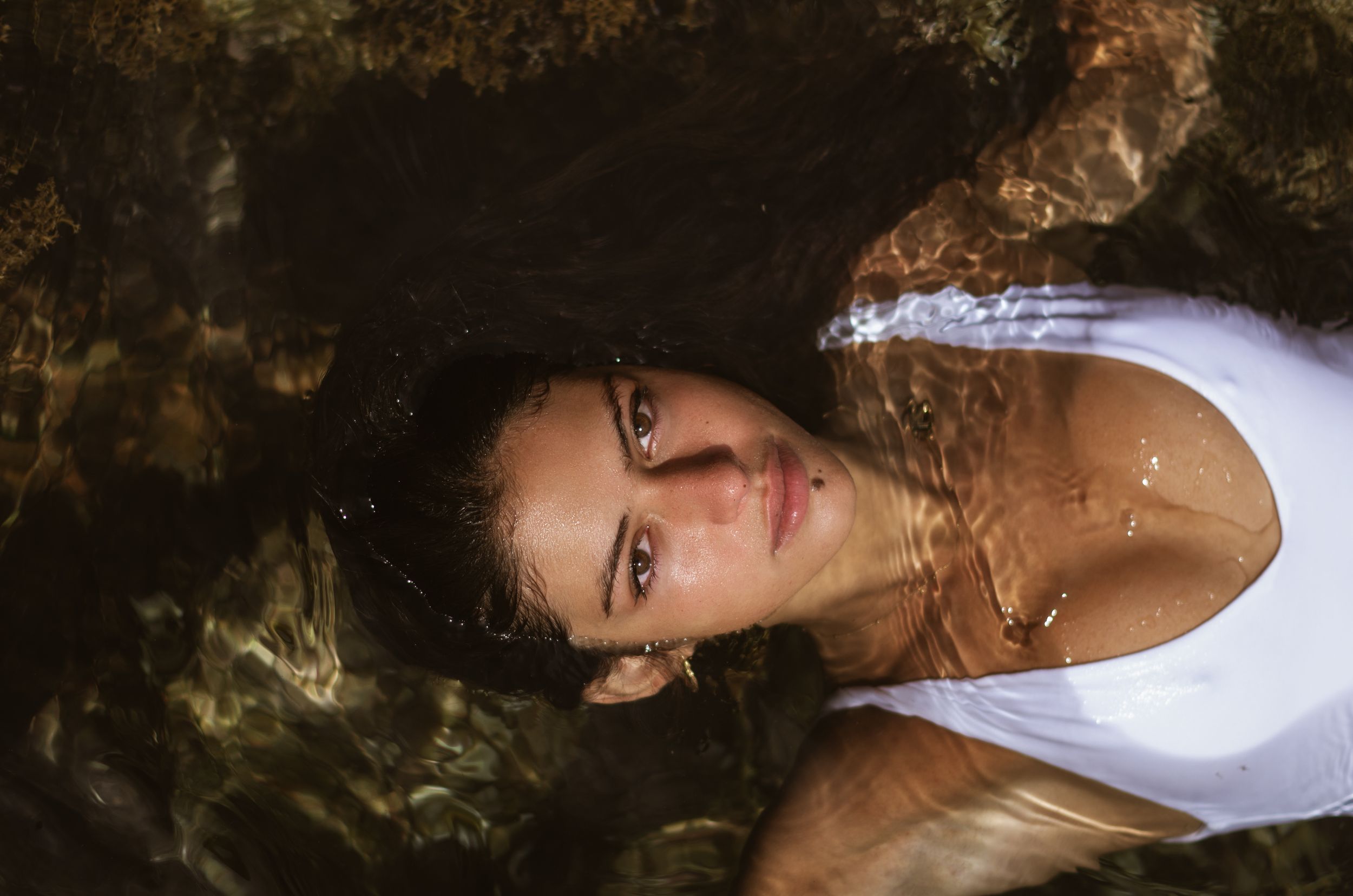 A series of artistic portrait photographs showing different poses and angles in dramatic lighting and shadows.