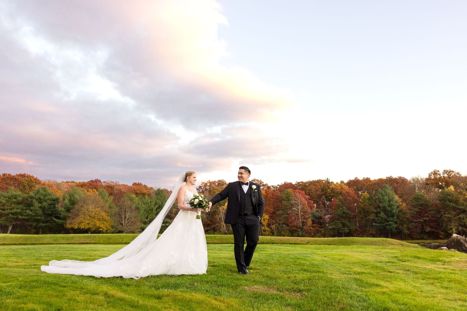 Married couple walking across a field