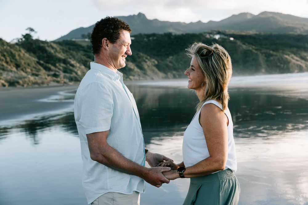 mum and dad at the beach in sunset