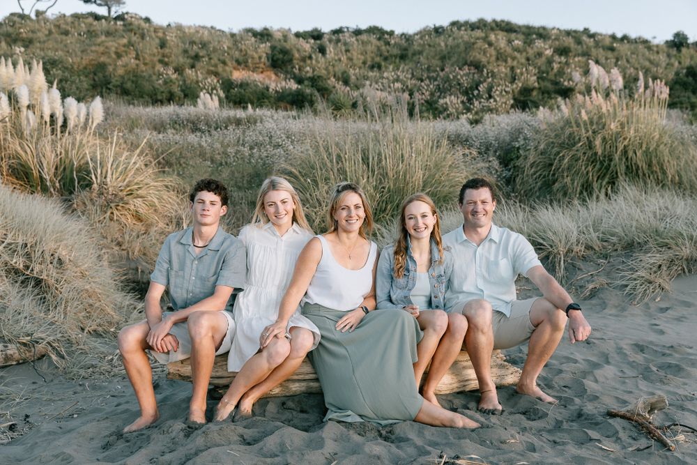 Family photo on the beach on a log