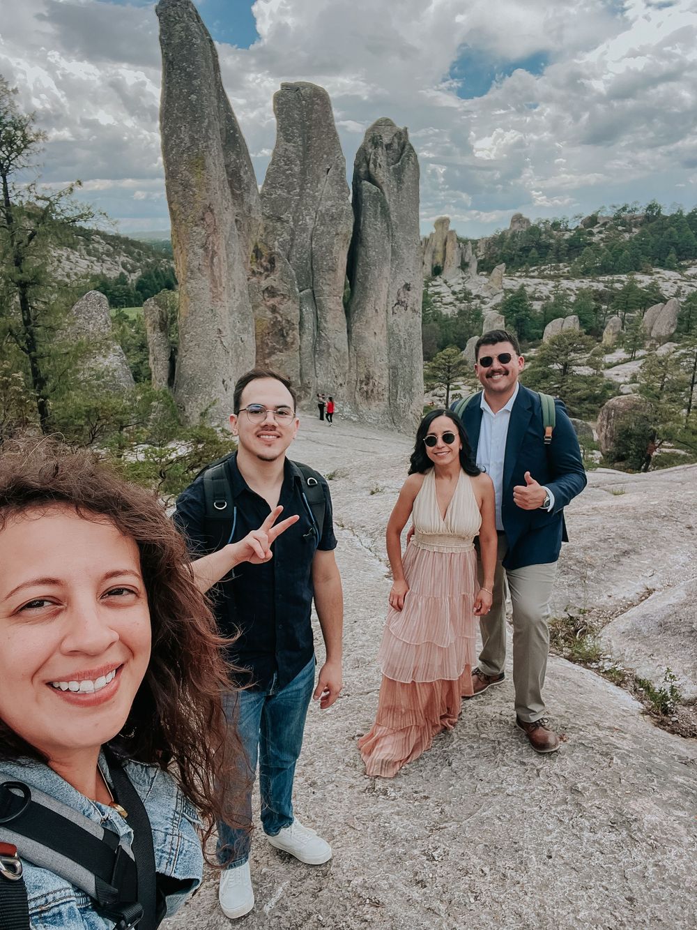Five photos showing people spending time together at a scenic rocky outdoor landmark on a sunny day with clouds.