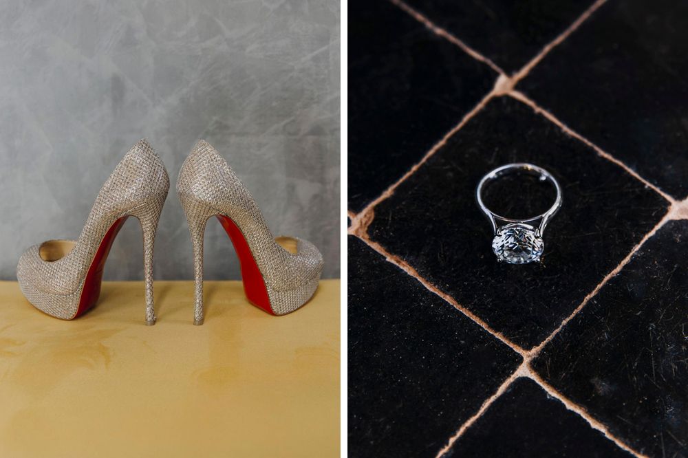A pair of sparkly silver high heels with red soles sits next to a stunning diamond engagement ring on a tiled surface.