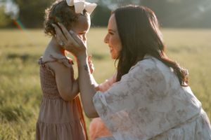 Candid photo sequence of a romantic couple embracing in a sun-drenched meadow at golden hour.