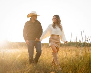 portrait of cinematic couple in field at golden hour