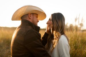 portrait of cinematic couple in field at golden hour