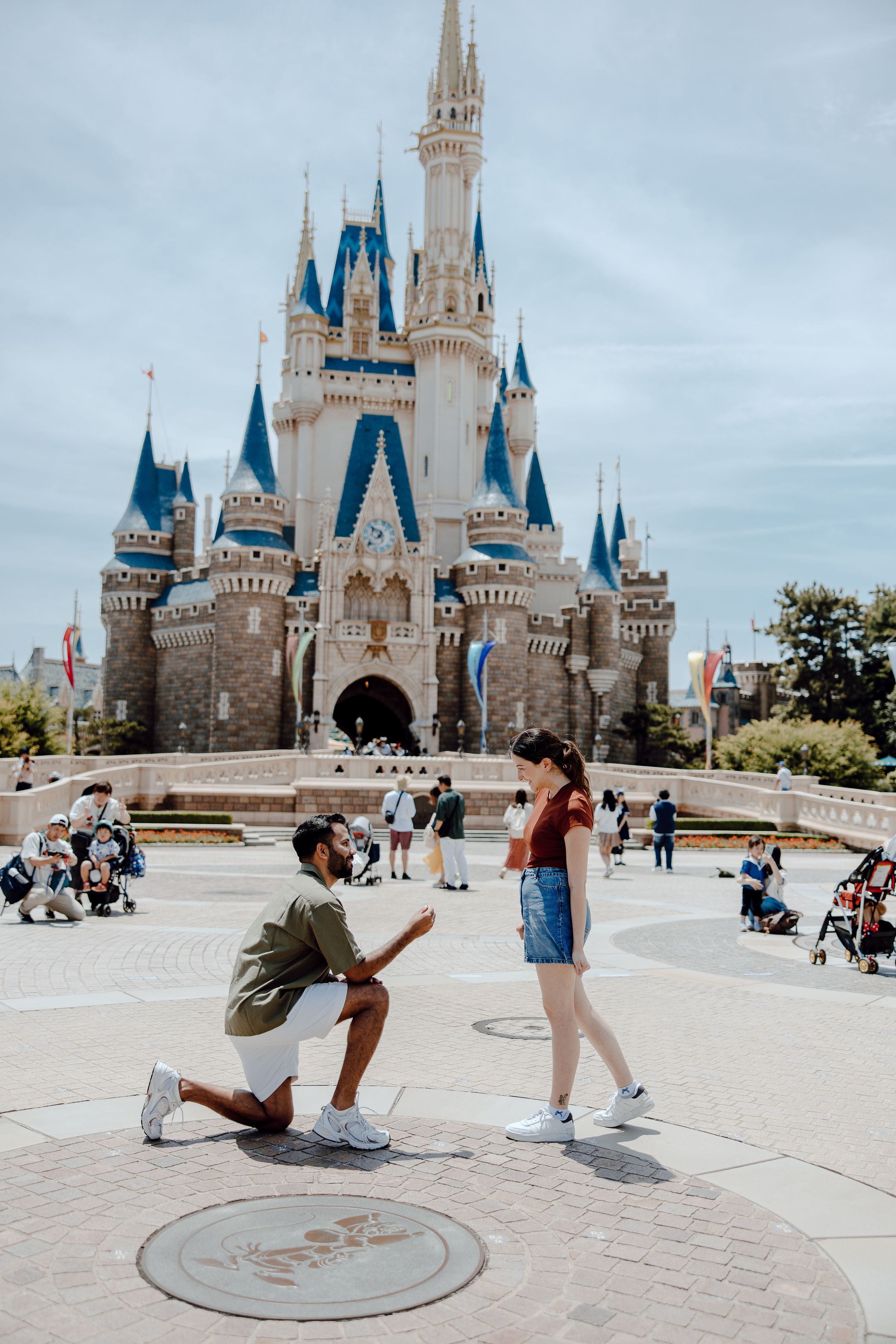 Photo sequence showing a surprise proposal moment in front of Cinderella Castle at Walt Disney World Magic Kingdom.