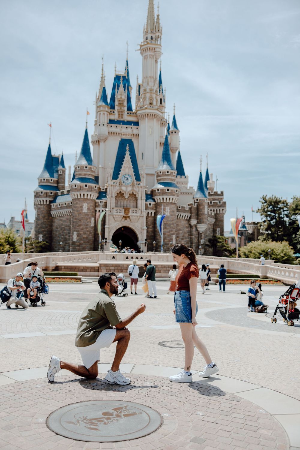 Photo sequence showing a surprise proposal moment in front of Cinderella Castle at Walt Disney World Magic Kingdom.