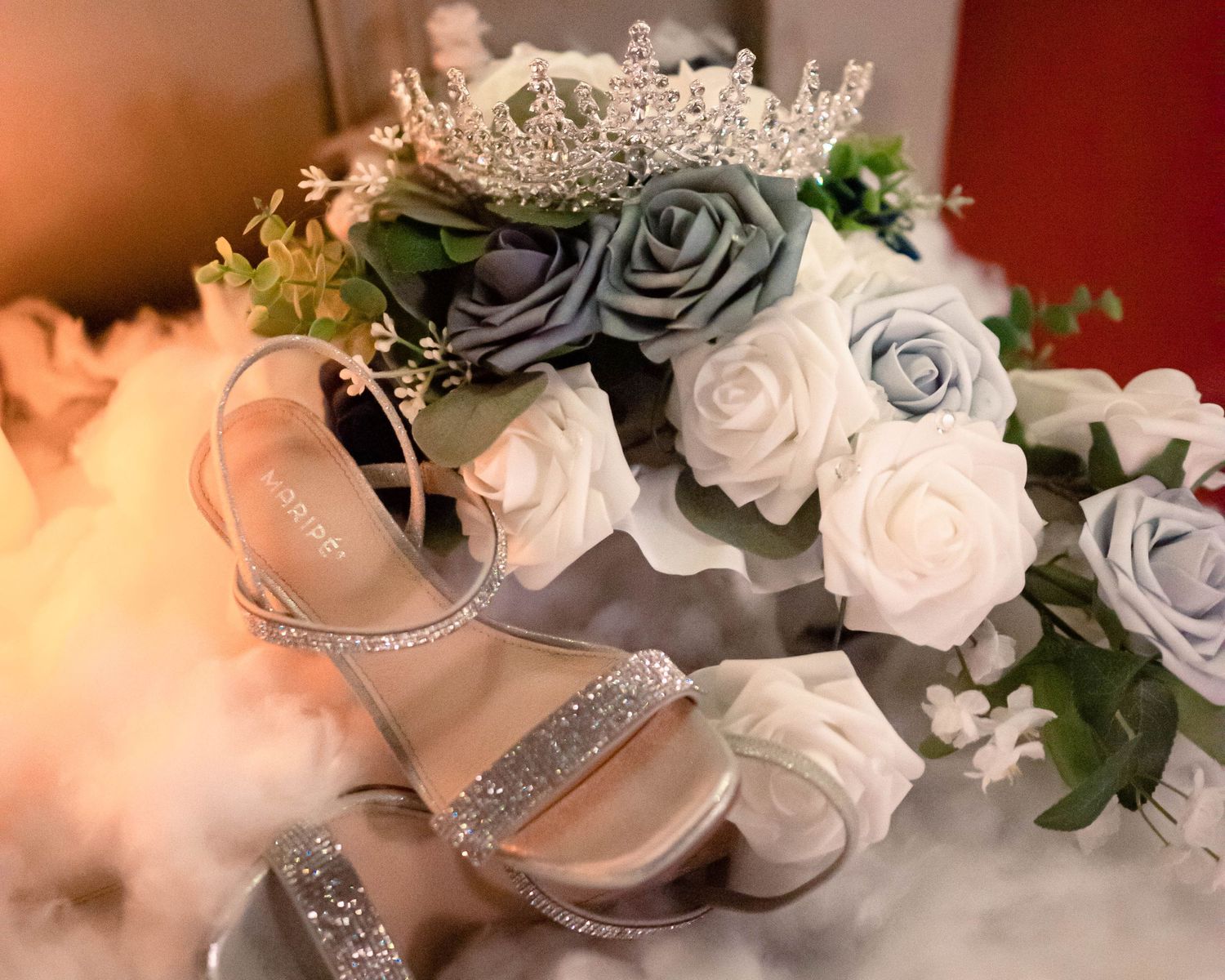 Elegant bridal accessories including silver shoes and white rose bouquet details.