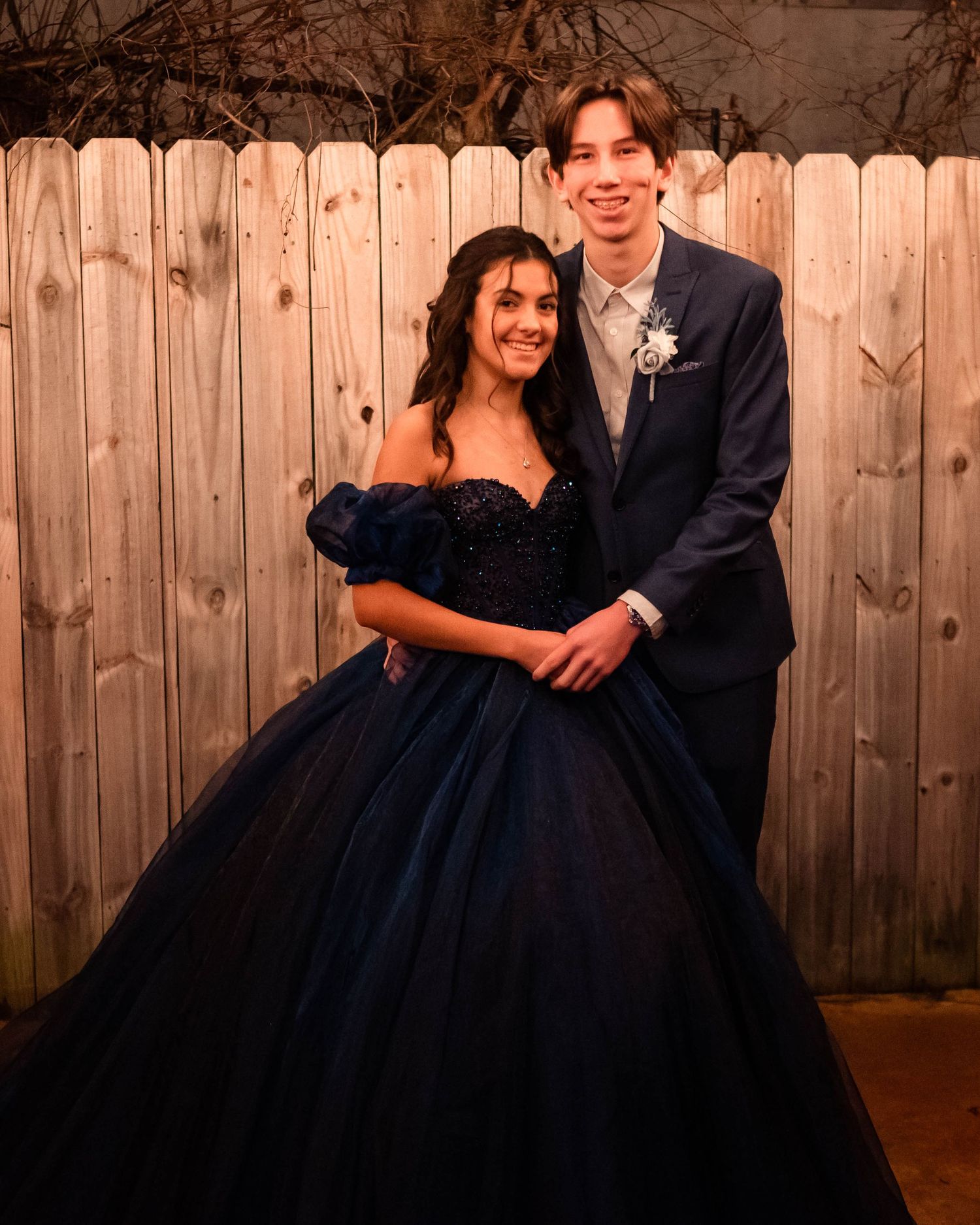 Romantic photo series against wooden fence background with formal attire.
