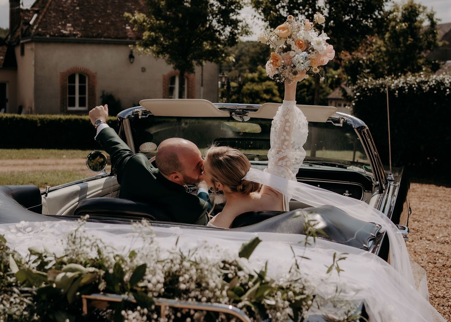 Outdoor wedding venue with elegant table settings and natural garden scenery.