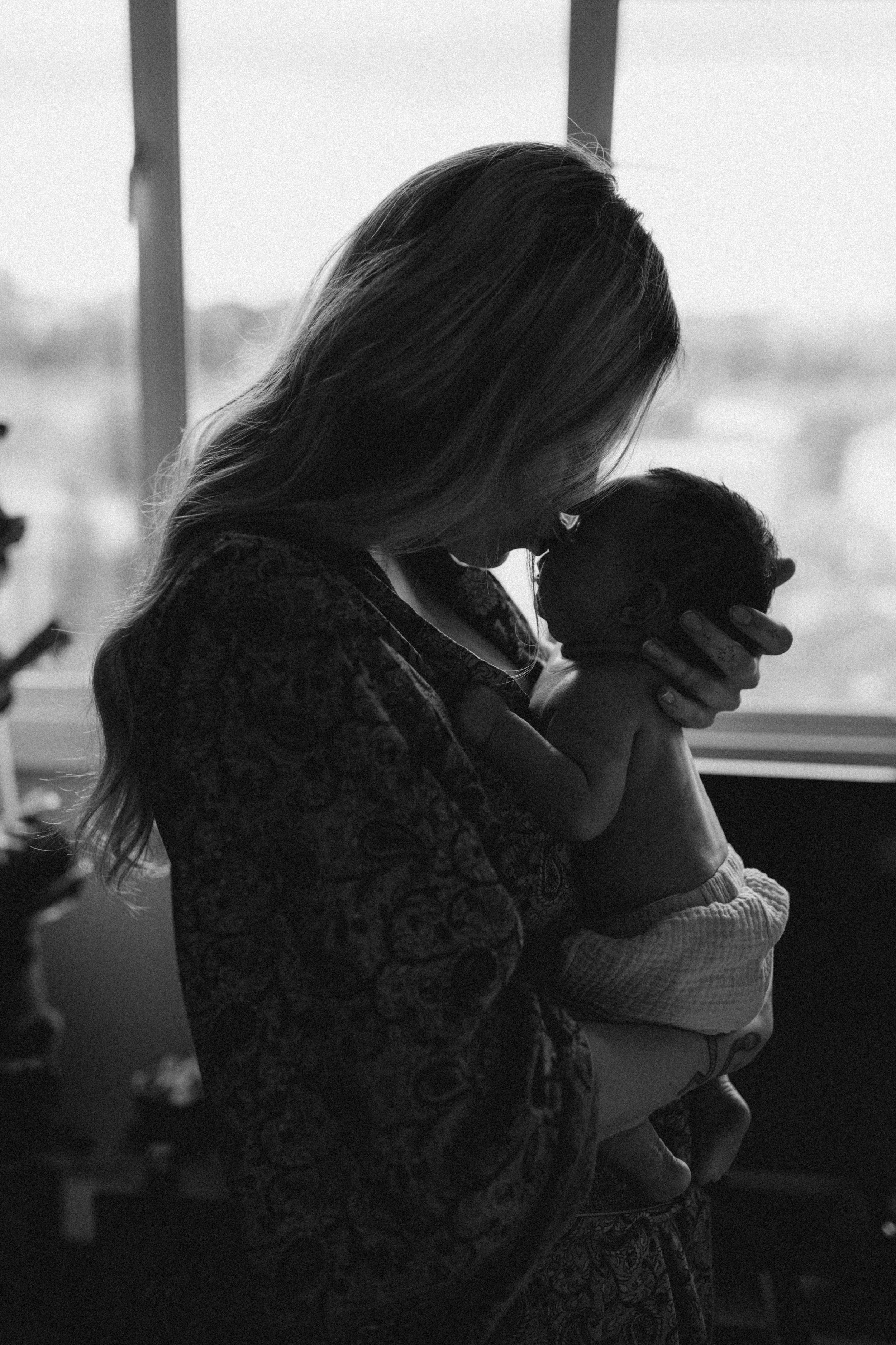 a mother holding her new born during a new born photo session with Forever Ours Photography in Kent