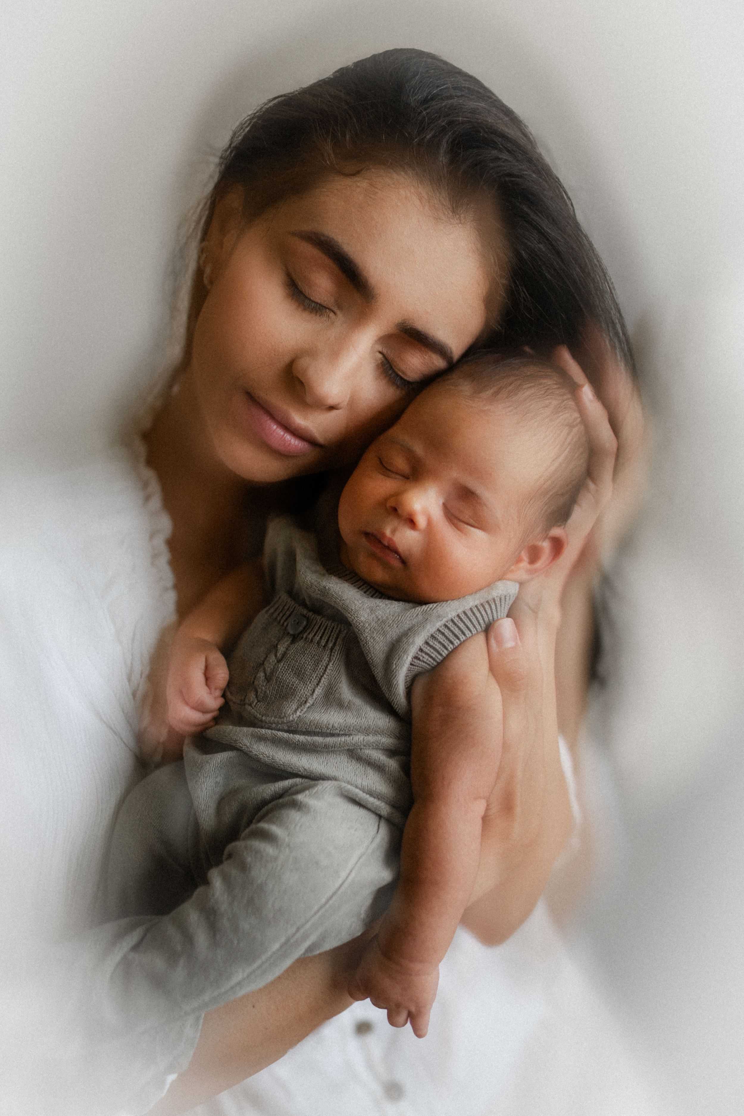 a mother holding her new born during a new born photo session with Forever Ours Photography in Kent