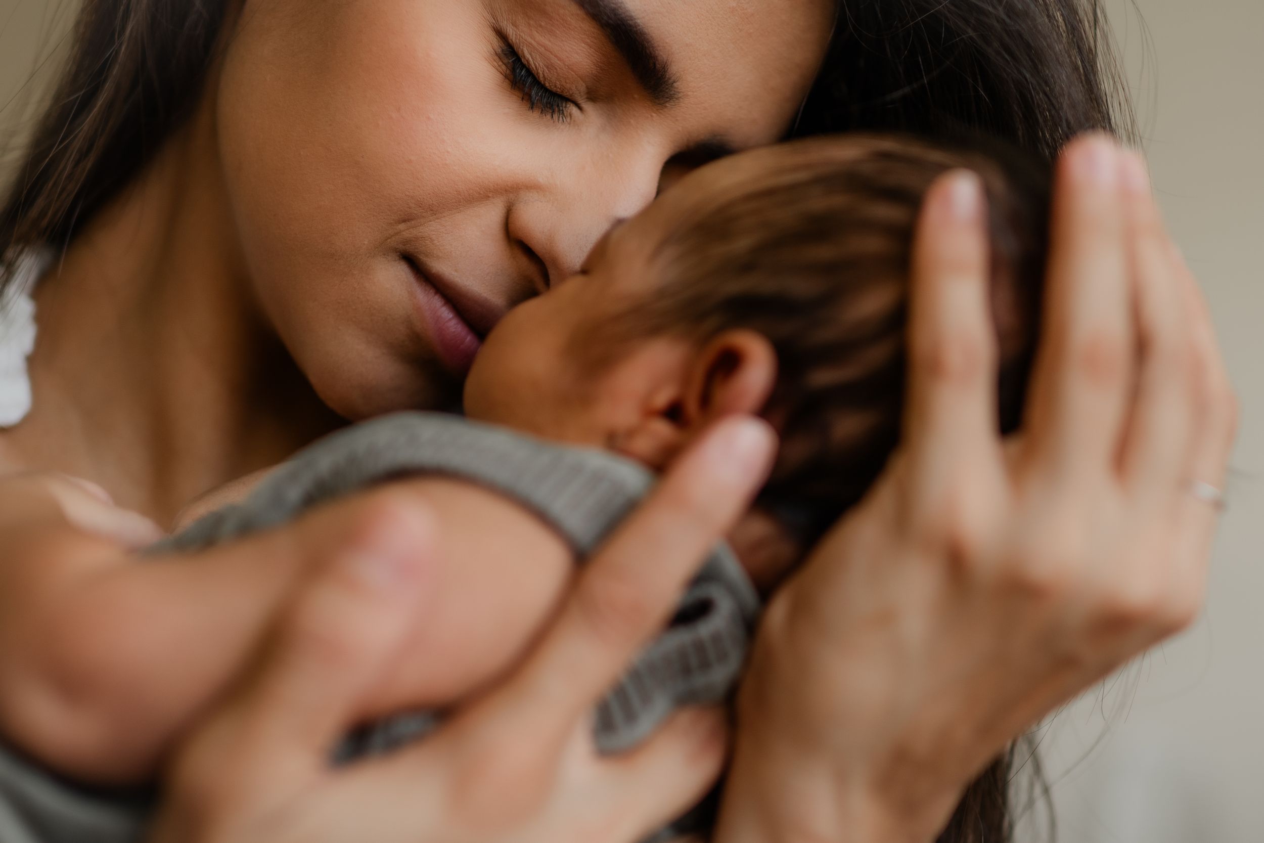 a mother holding her new born during a new born photo session with Forever Ours Photography in Kent