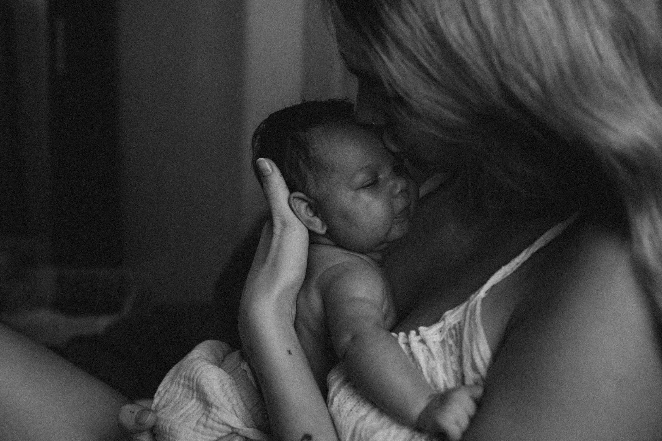 a mother holding her new born during a new born photo session with Forever Ours Photography in Kent