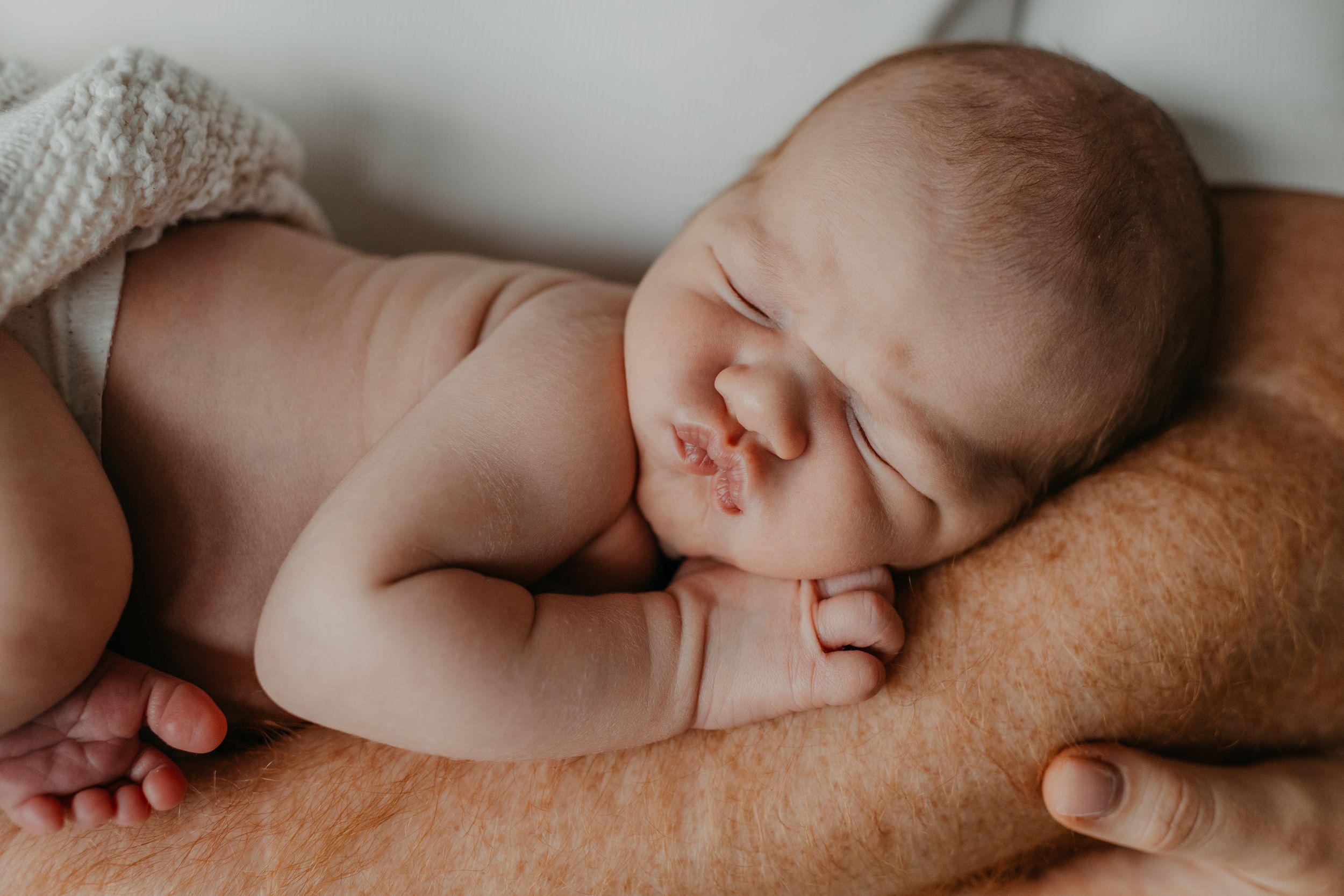 a new born during a new born photo session with Forever Ours Photography in Kent