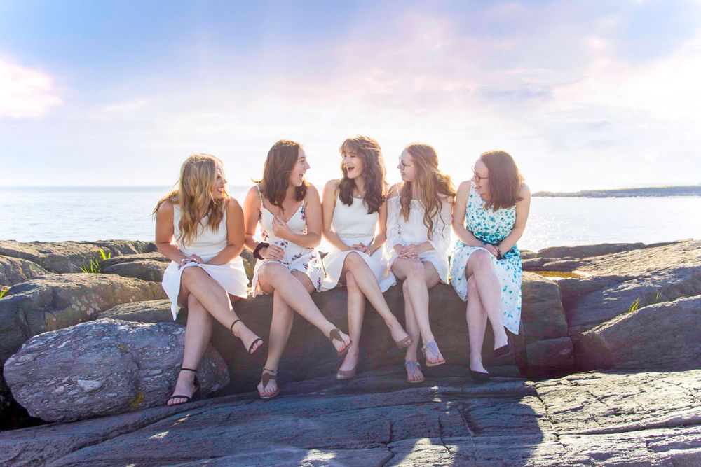 Group graduation photo of girls laughing amongst themselves in Yarmouth, NS, by Daneesha WIlliams