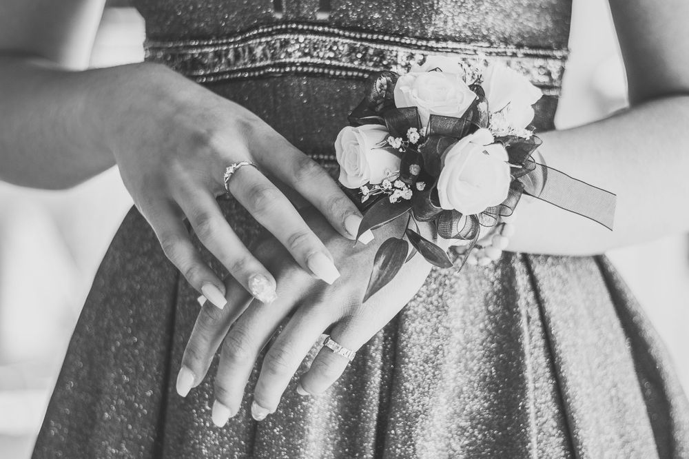 Beautiful black and white detail photo of prom dress, corsage, and manicured nails by Daneesha Williams