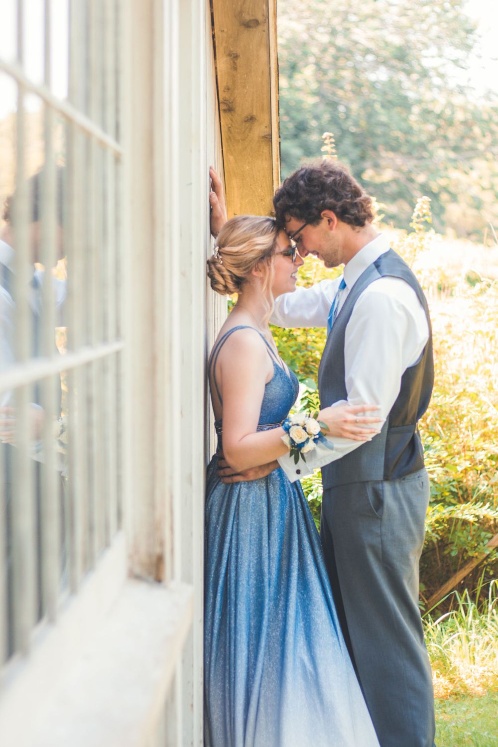 Outdoor portrait of a prom couple in a closed pose, touching foreheads, by Daneesha Williams Photography
