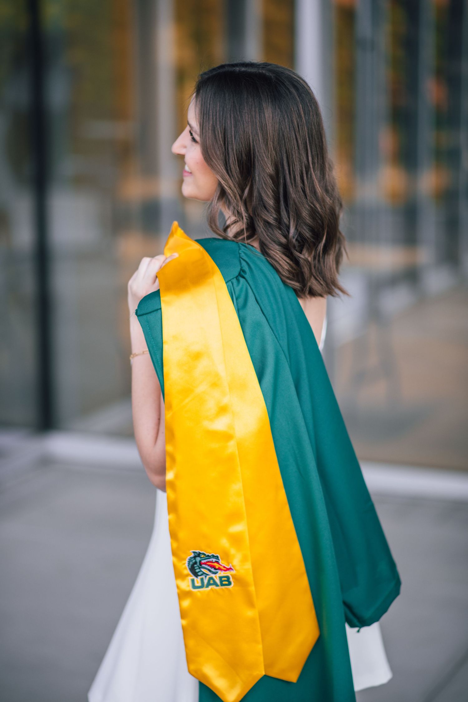 UAB senior holding stole and gown, Birmingham Alabama senior photographer, affordable graduate photographer in Birmingham Alabama.