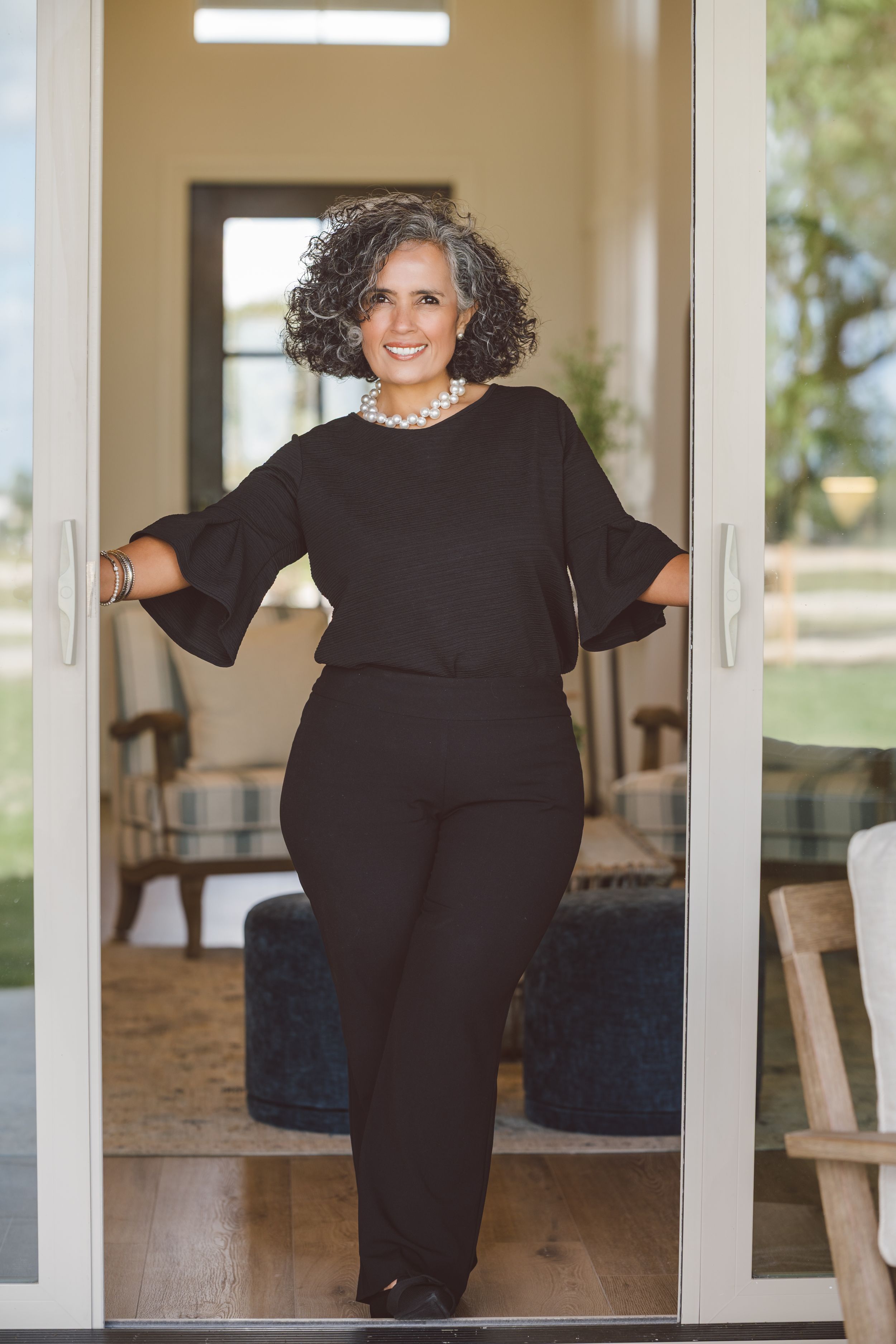 A person in a black outfit poses playfully in a series of connected photos showing different poses and expressions.