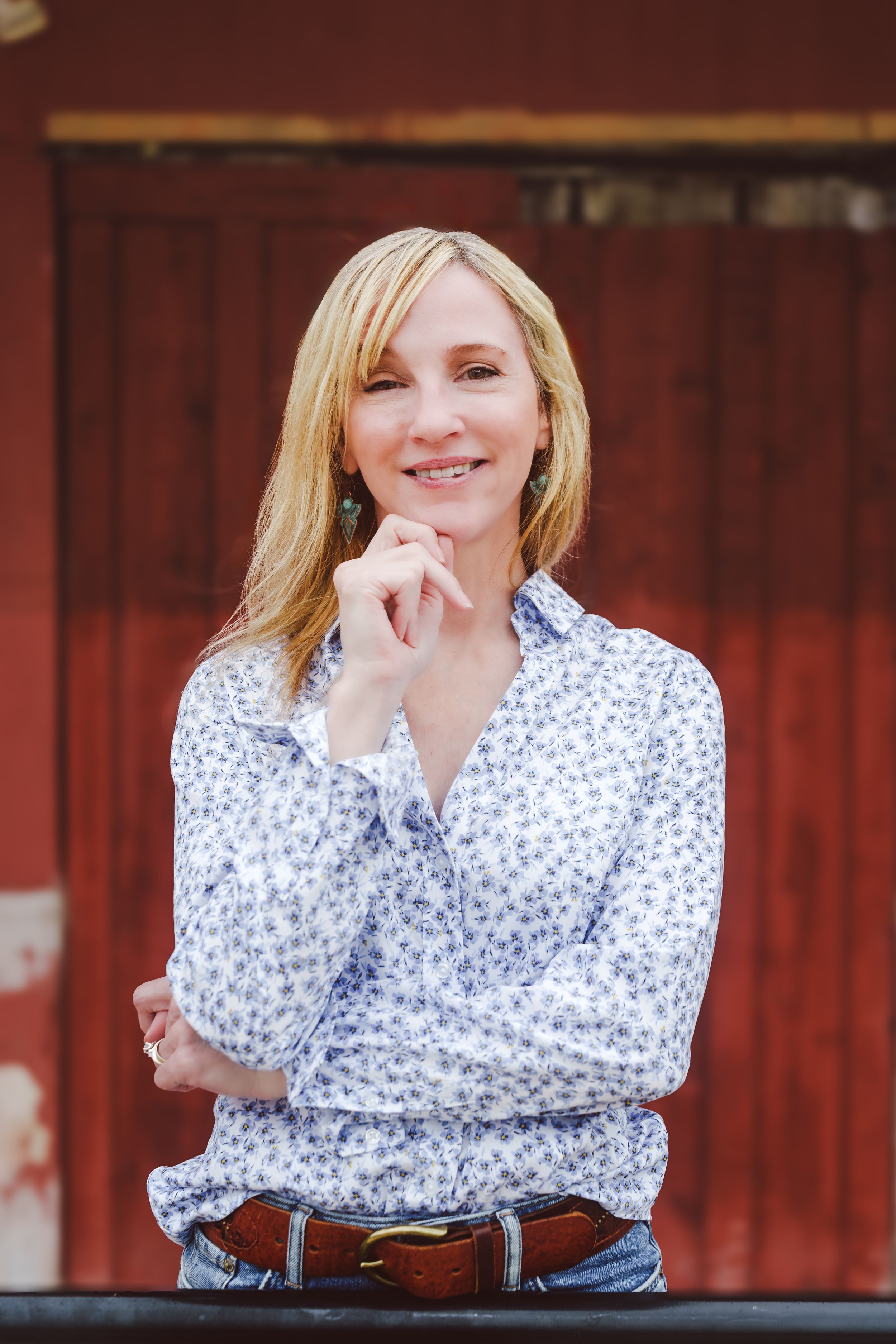 A person wearing a blue floral shirt poses in multiple shots against a rustic red barn background.