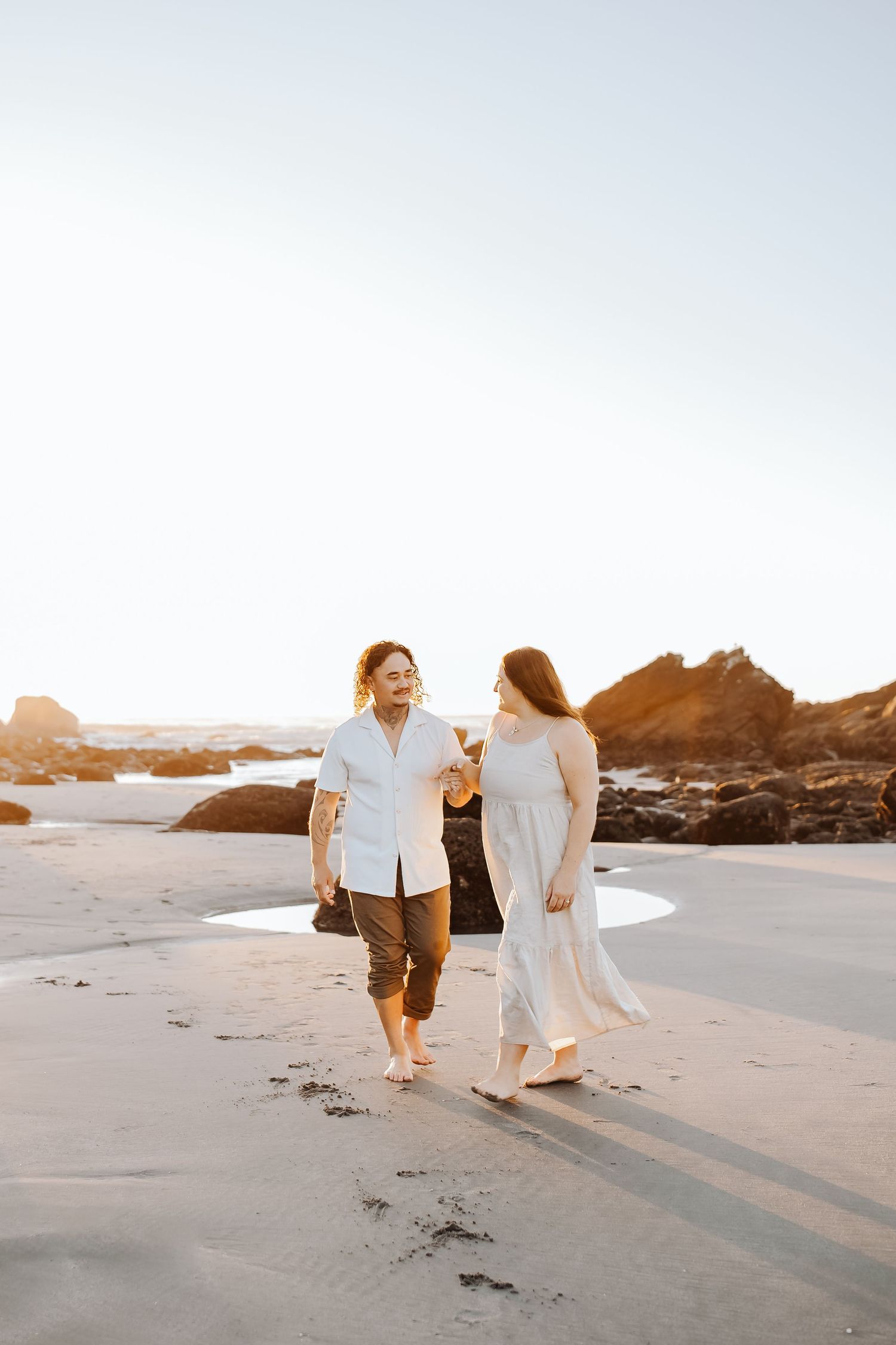Couples session, in love and recently engaged. captured naturally during golden hour at the beach in Westport NZ