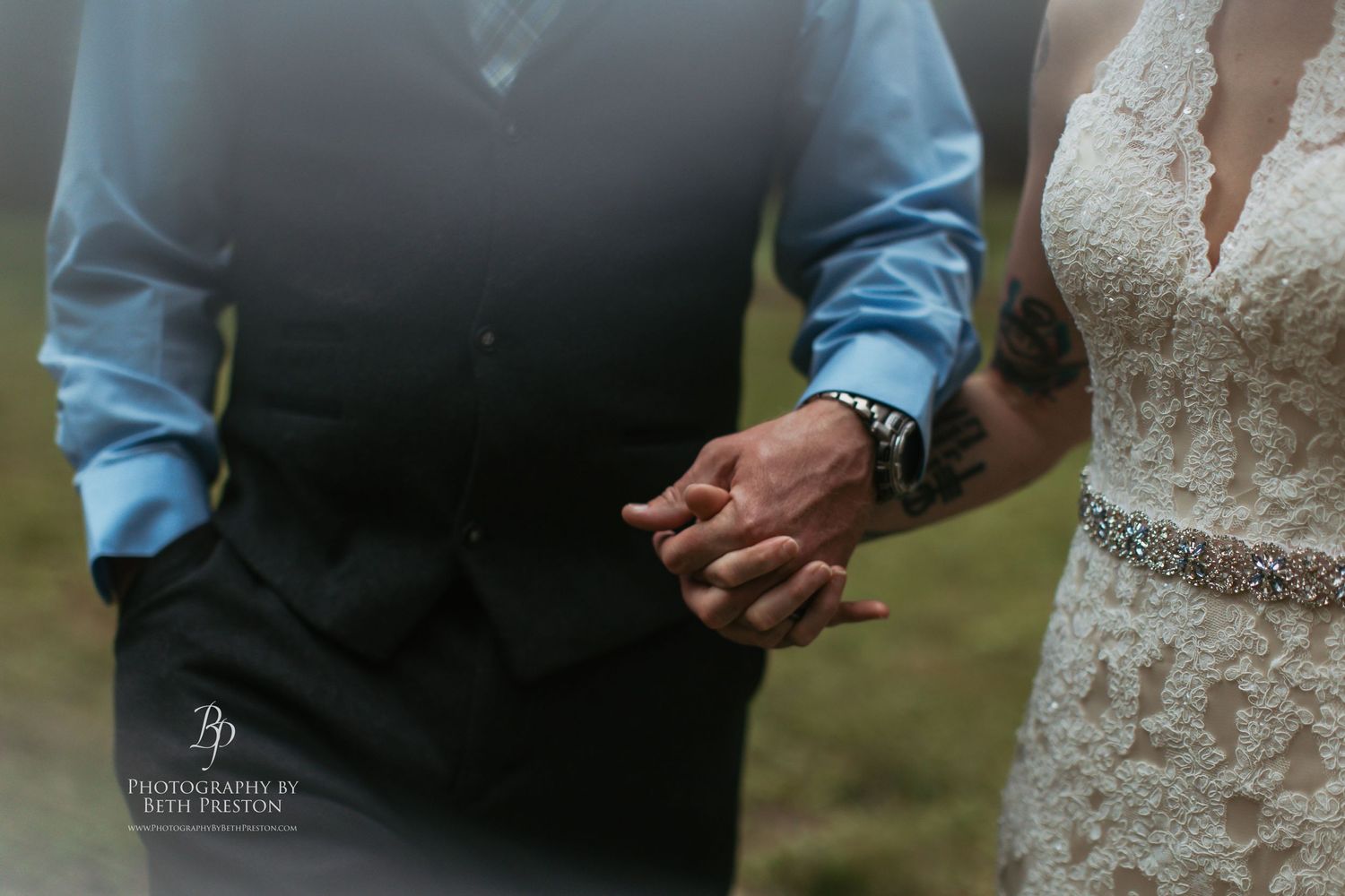Close-up detail of joined hands during an intimate wedding ceremony.