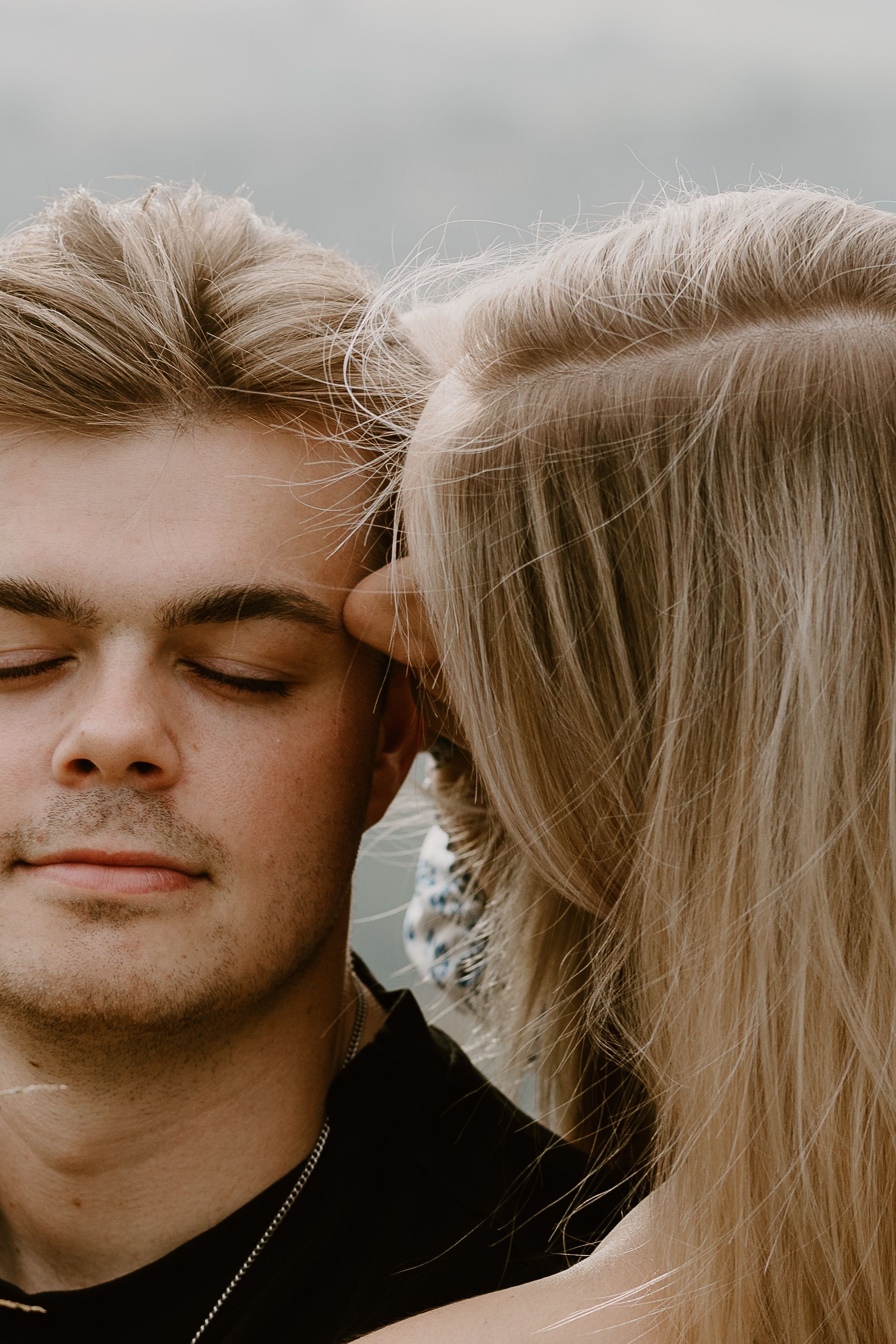 woman kissing mans temple