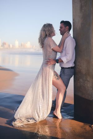 couple kissing against bridge