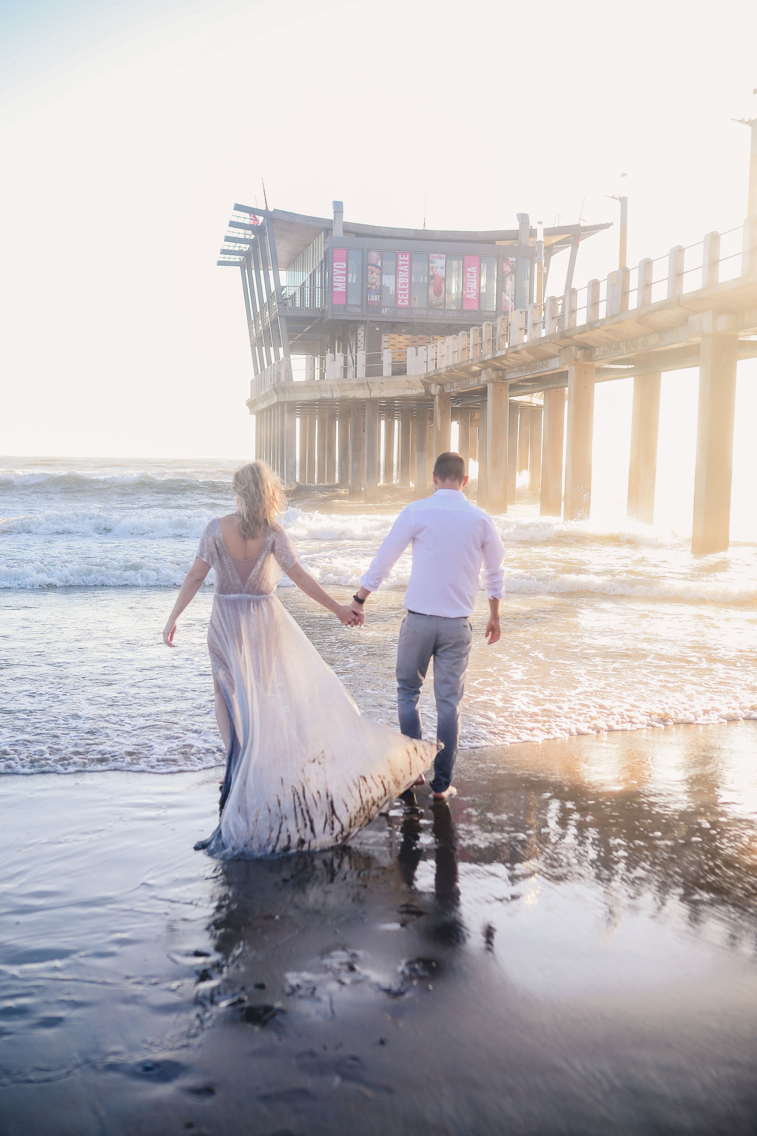 couple walking  into ocean