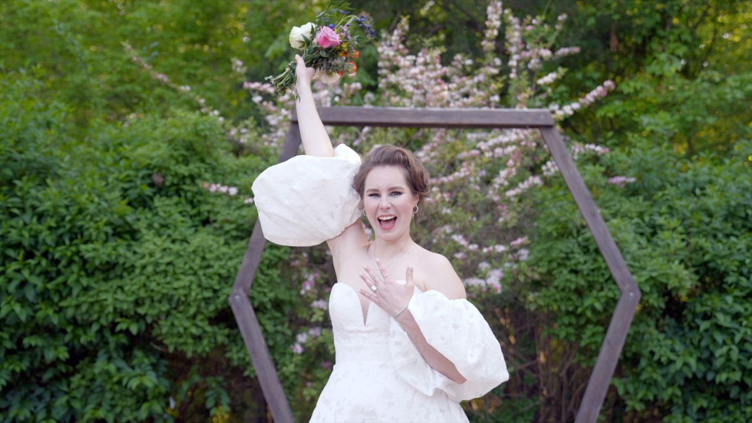 Girl in a wedding dress is happy showing her engagement ring