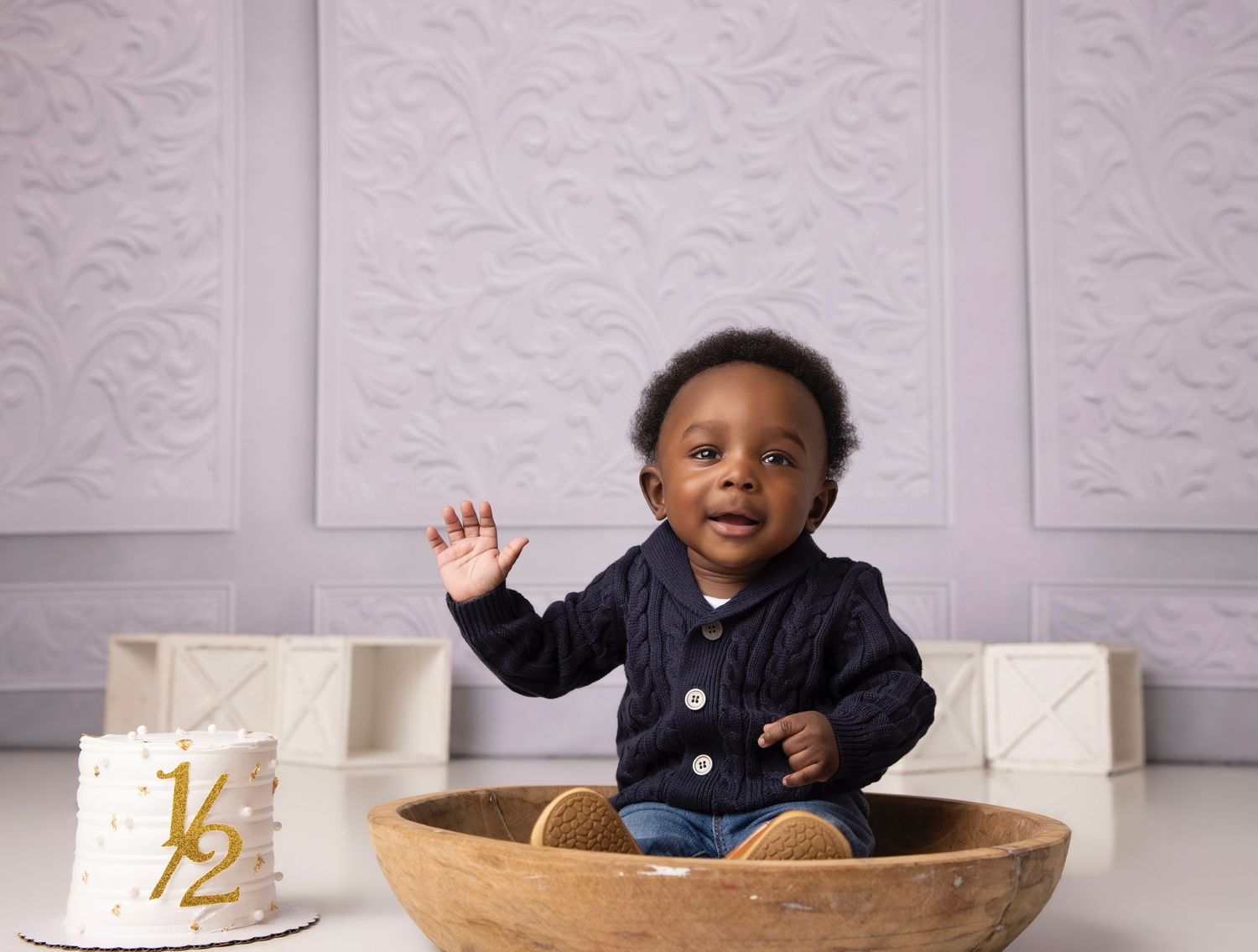 White studio setup with textured walls and wooden bowl prop for photography.