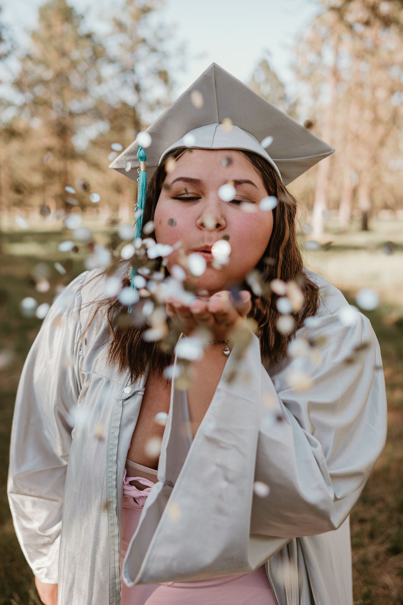 Graduation photos showing confetti being thrown in the air while wearing a cap and gown.