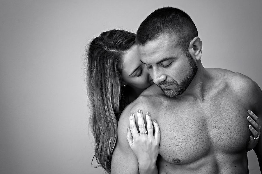 Intimate black and white portrait of couple sharing tender moment together.