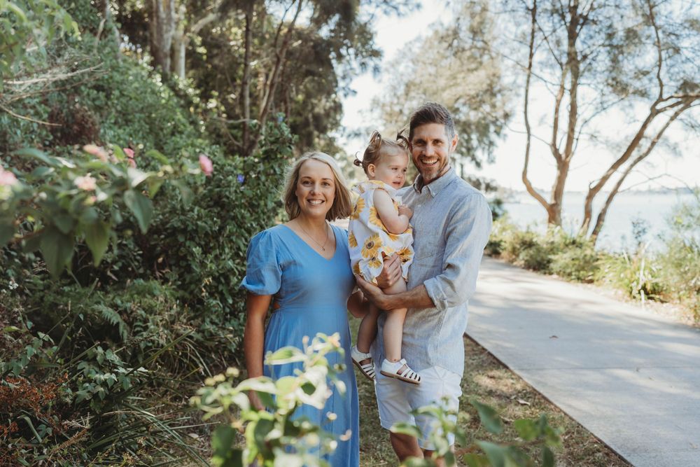 Family posing at Green Point Foreshore Reserve during Lake Macquarie family photoshoot