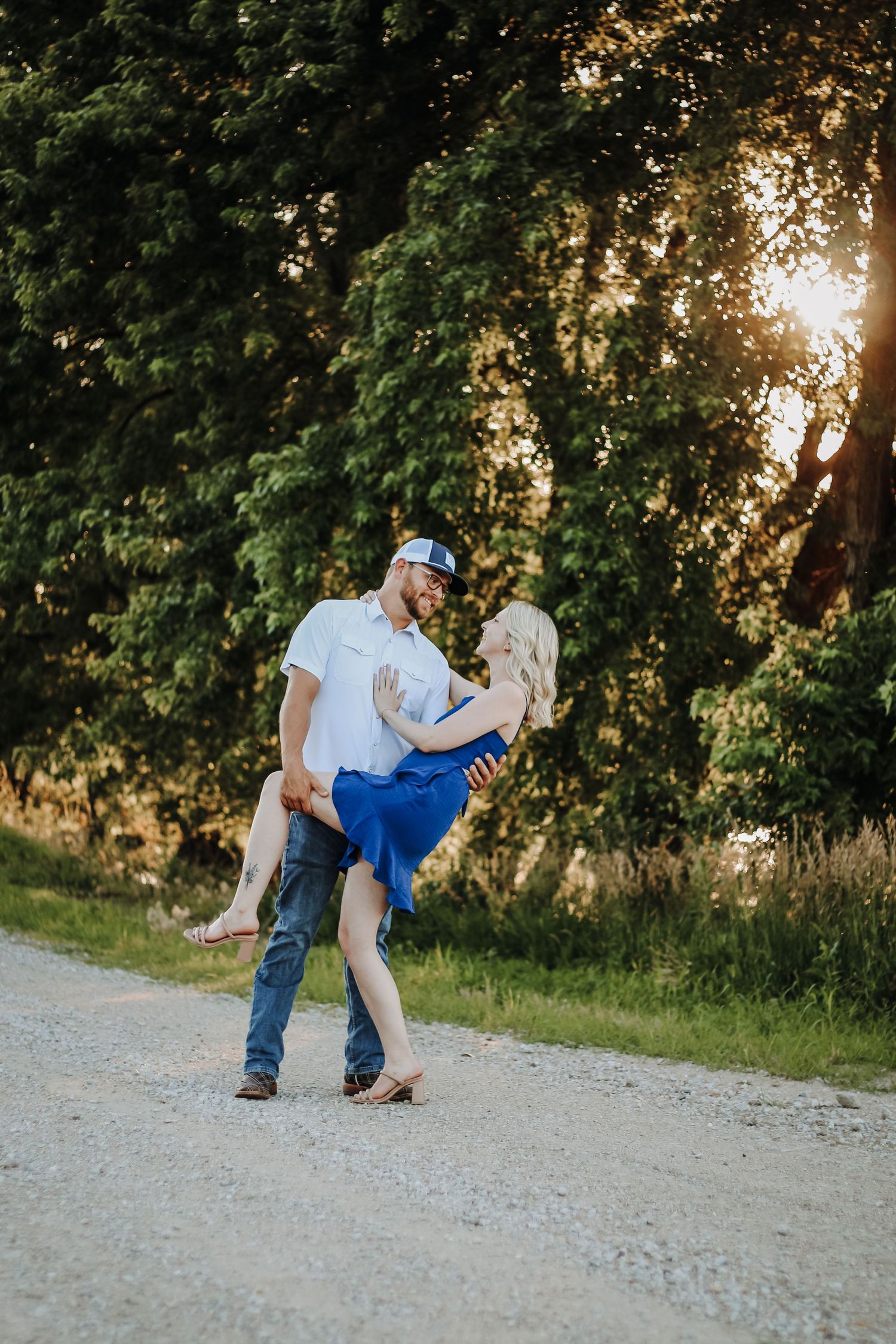 Romantic dance sequence on a gravel path with trees and sunset in background. Couples photography