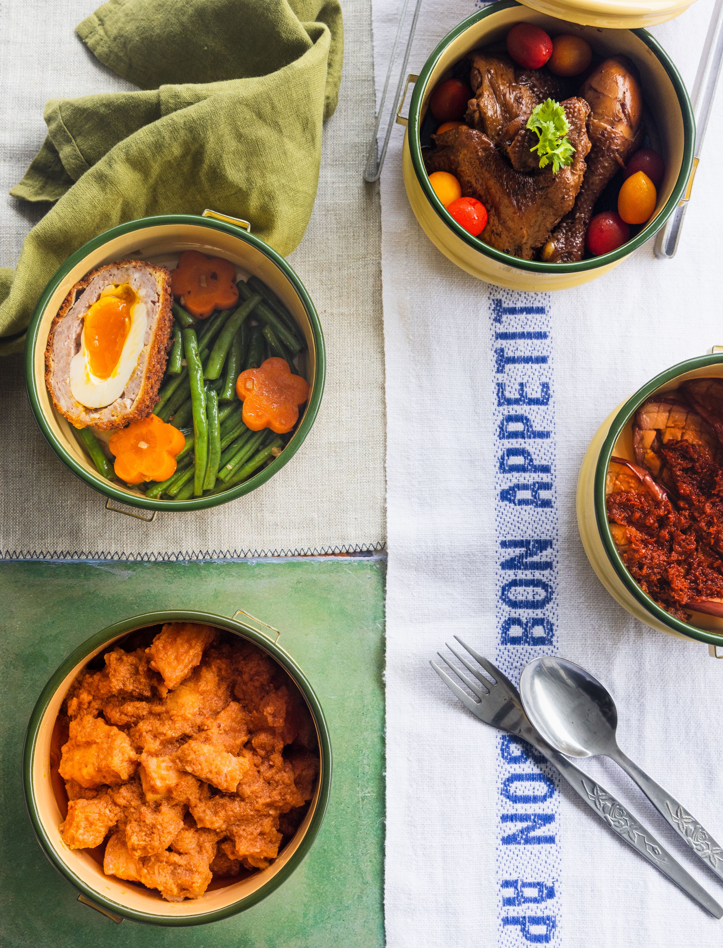 Assorted Asian dishes in colorful bowls with eggs, meat, and vegetables.