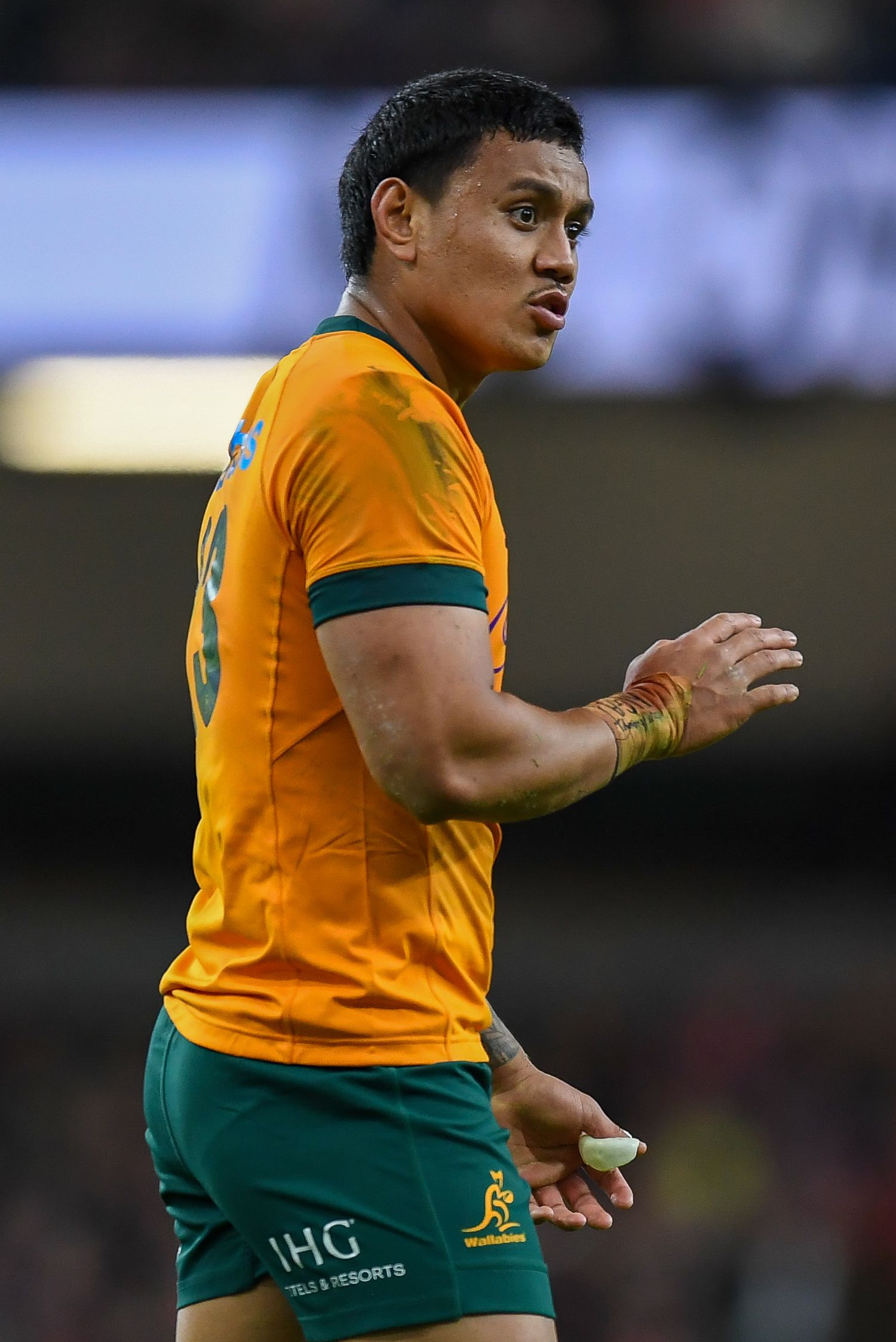 Rugby player in gold Australia national team jersey during competitive match.