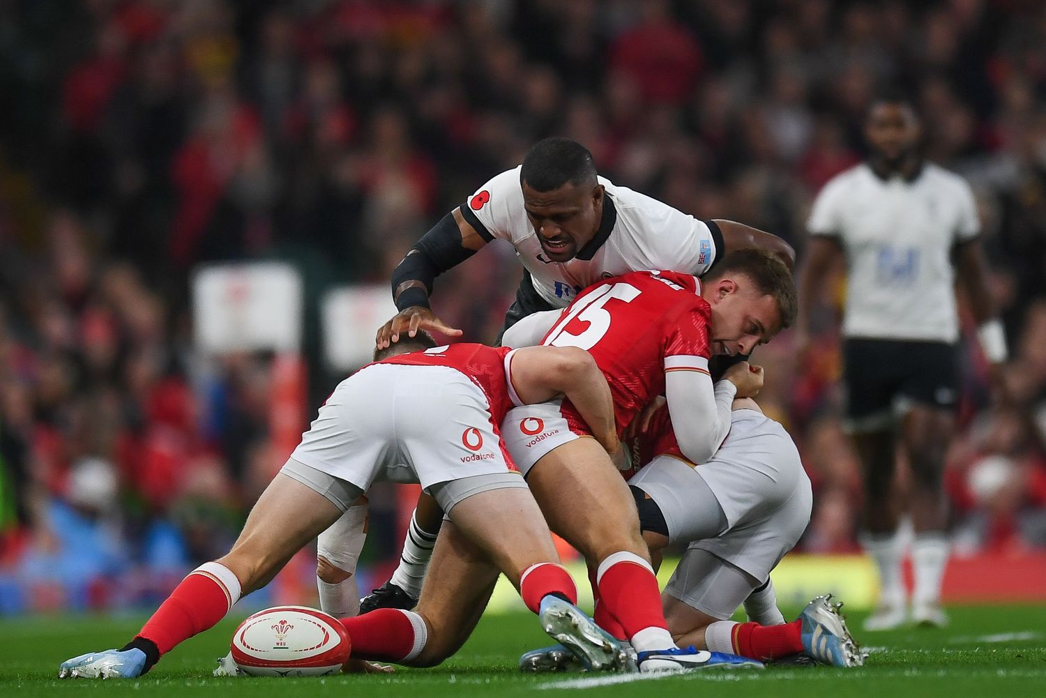 Rugby players scramble for the ball during competitive match play.