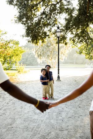A sequence of photos showing people playing frisbee in a park under shady trees.