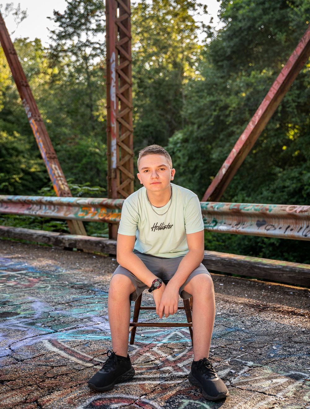 Teen boy sitting in chair, Cry Baby Bridge, Anderson, South Carolina