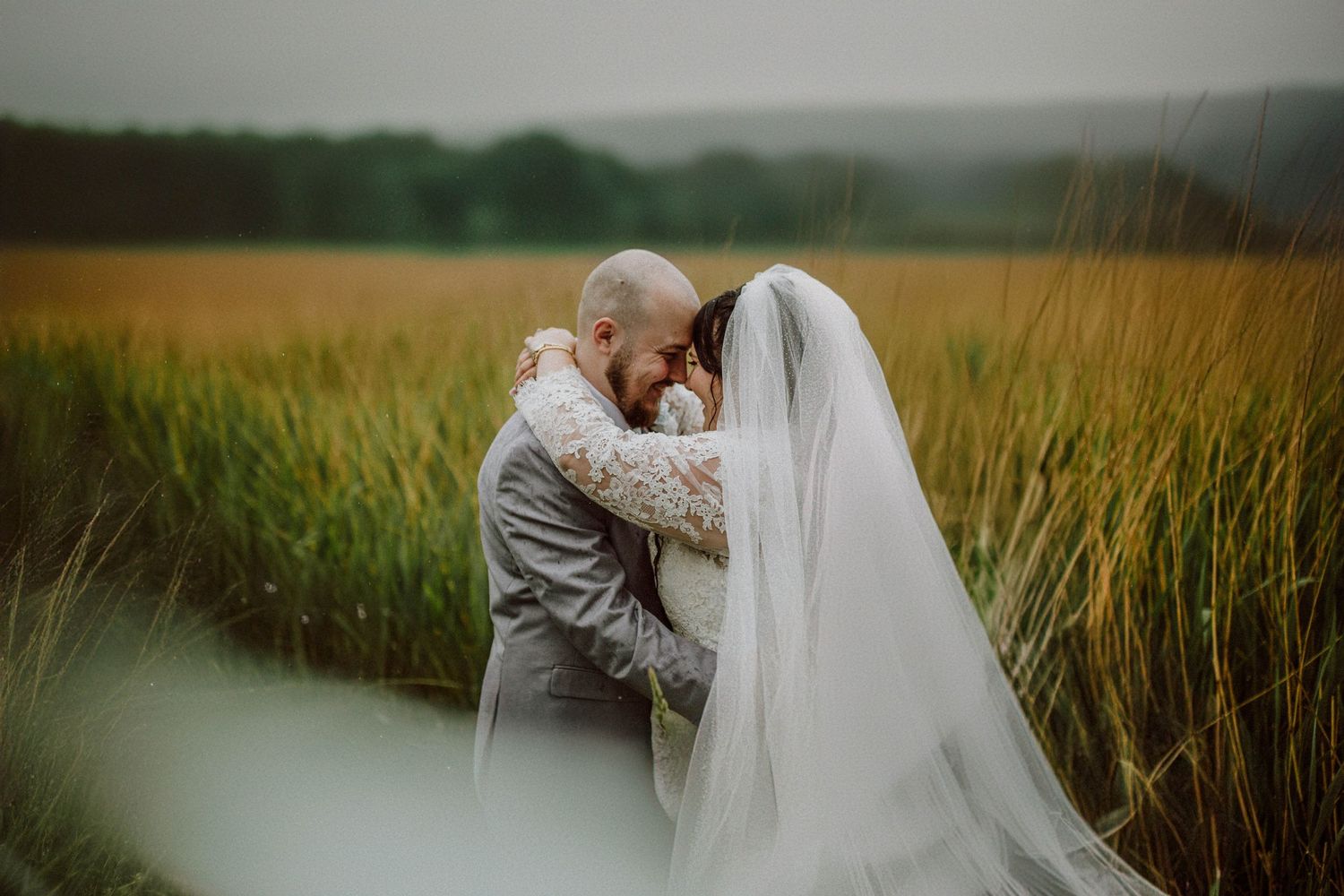 An intimate moment between newlyweds in a serene wheat field.