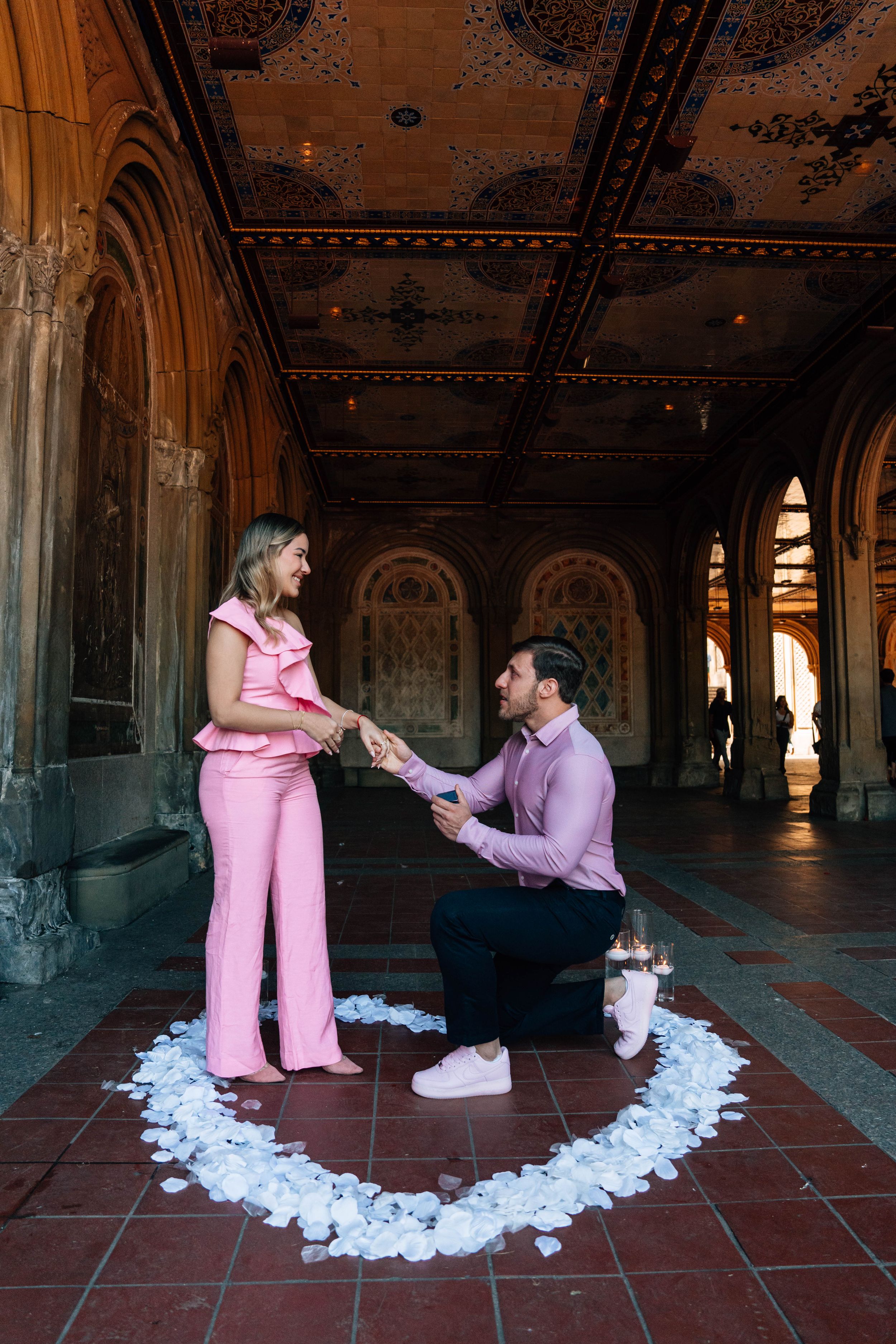 A romantic proposal sequence shows a couple in pink and purple attire against an ornate architectural backdrop.