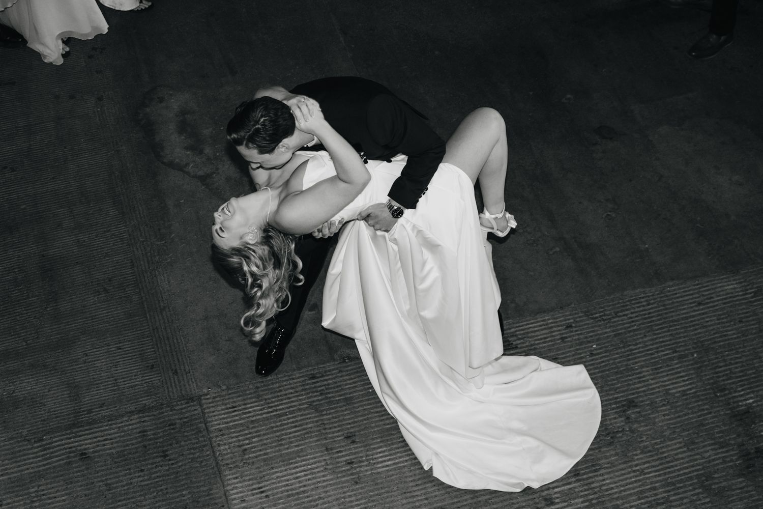 A dynamic black and white photo sequence shows a white-dressed figure twirling in graceful dance movements.