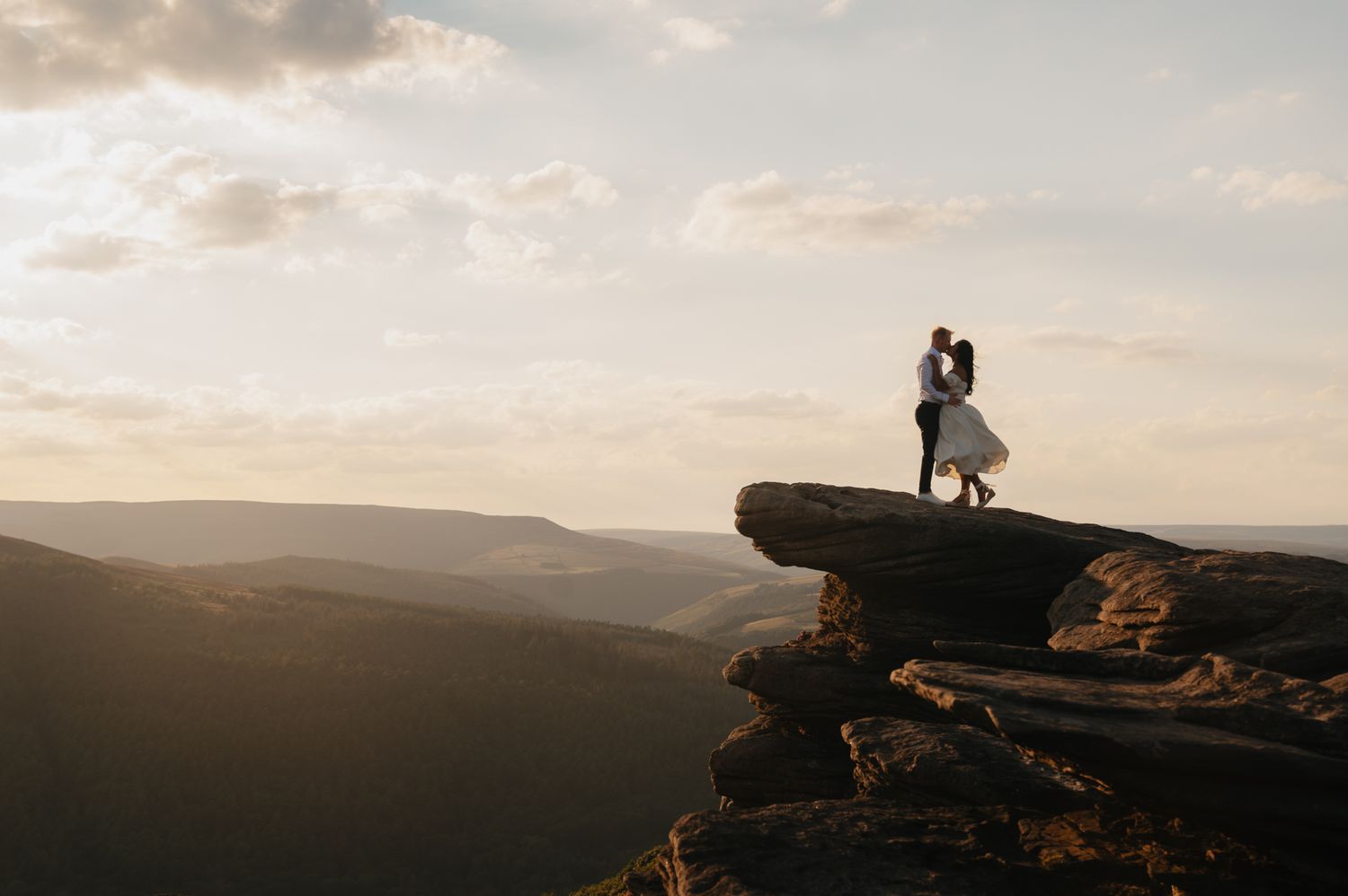 Silhouette of a couple enjoying sunset at McAfee Knob on the Appalachian Trail in Virginia.