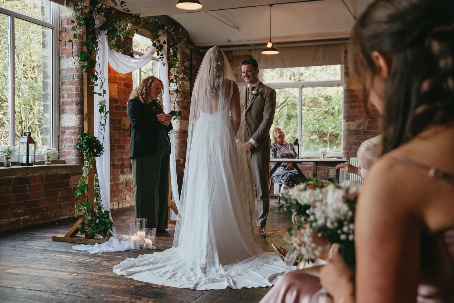Row of wedding preparation photos showing floral arrangements and a flowing white dress in a rustic brick venue. The Venue, Halifax
