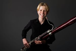 Professional musician poses with bassoon instrument against dark background in multiple artistic portraits.