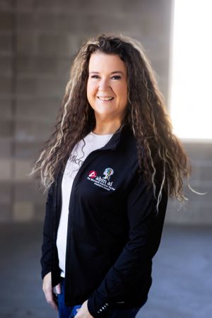 Person in business attire poses confidently for professional brand photos.