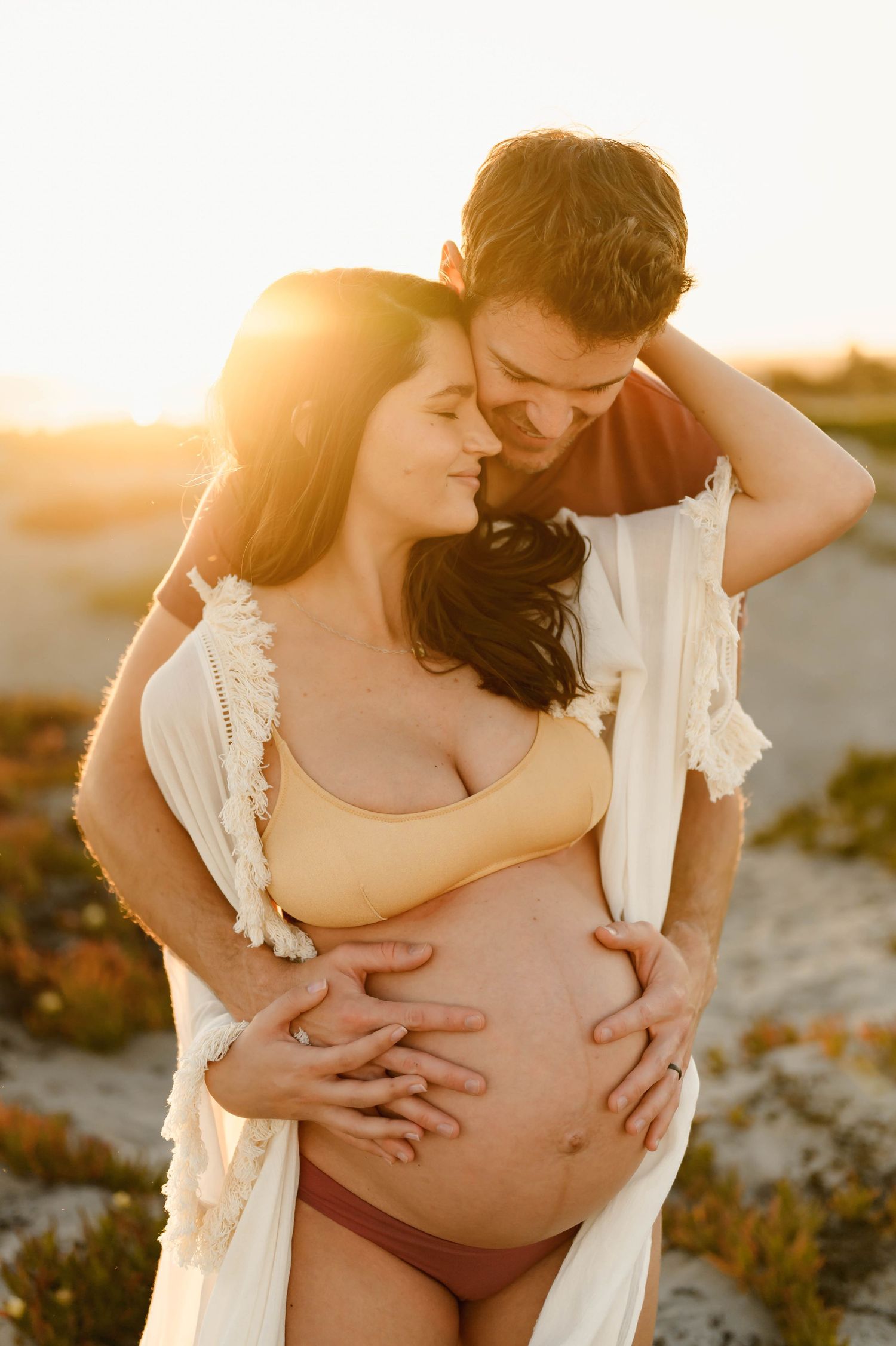 Carpinteria Beach bikini maternity photos during sunset of woman in bathing suit, by Santa Barbara maternity photographer