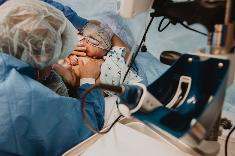Healthcare provider in surgical gear performs precise medical care during a clinical procedure.